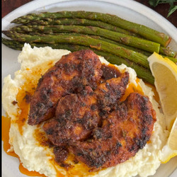 Chicken Tenders In A Cajun Lemon Butter Sauce On A Bed Of Creamy Mashed Potatoes And A Side Of Roasted Asparagus